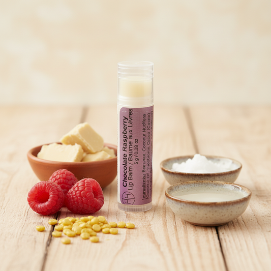 Chocolate Raspberry lip balm tube displayed with fresh raspberries and natural ingredients on wooden surface