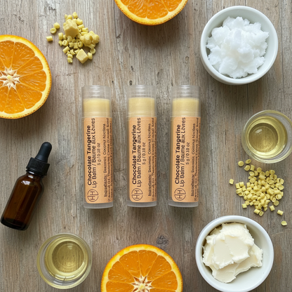 Chocolate Tangerine lip balm tubes surrounded by orange slices and natural ingredients on wooden surface